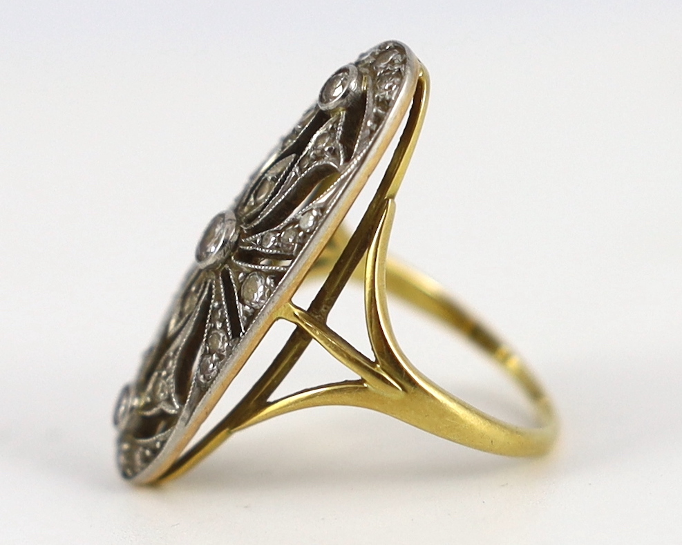 An Edwardian gold and diamond cluster set pierced up-finger ring